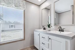The BREEZE FARMHOUSE 72 Primary Bathroom. This Manufactured Mobile Home features 4 bedrooms and 2 baths.