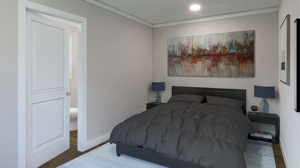 The STILL THE ONE Primary Bedroom. This Manufactured Mobile Home features 2 bedrooms and 2 baths.