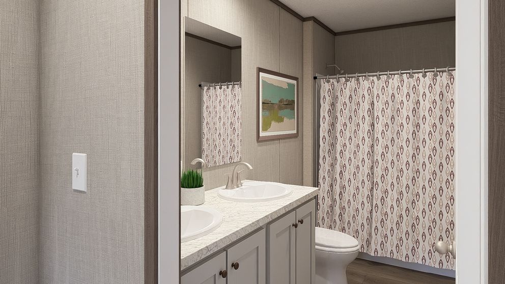 The LEGEND BIG BOY Guest Bathroom. This Manufactured Mobile Home features 4 bedrooms and 2 baths.