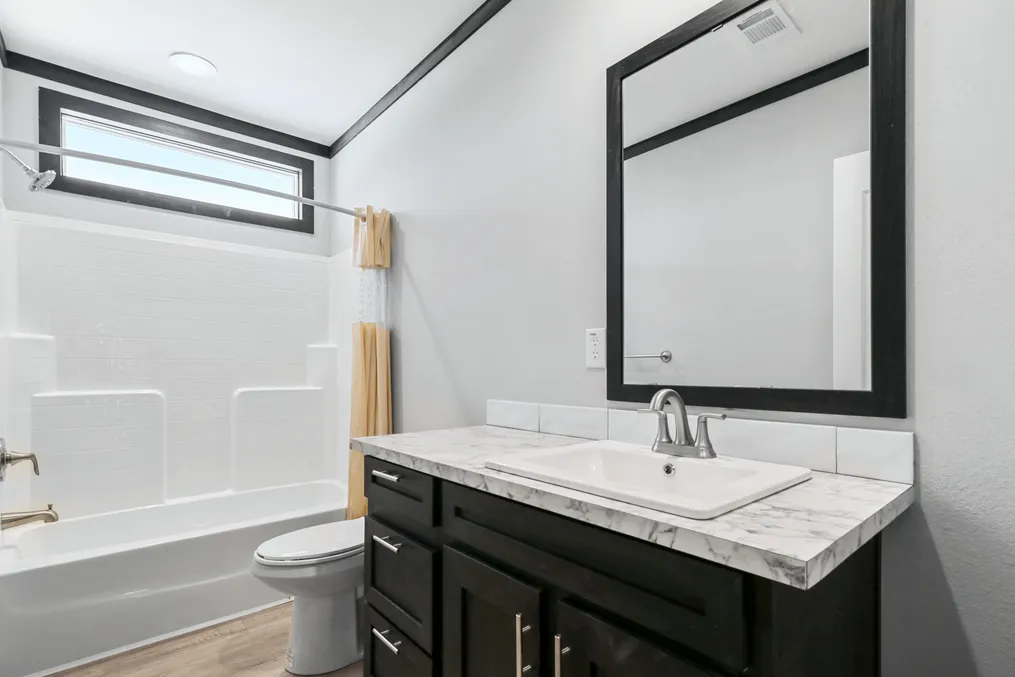 The THE ARMANI Guest Bathroom. This Manufactured Mobile Home features 3 bedrooms and 2 baths.