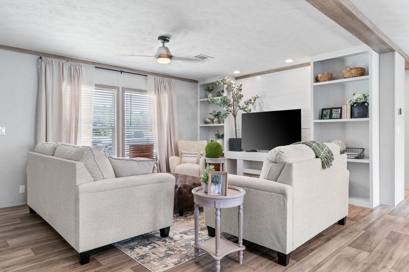 The THE REAL DEAL Living Room. This Manufactured Mobile Home features 3 bedrooms and 2 baths.