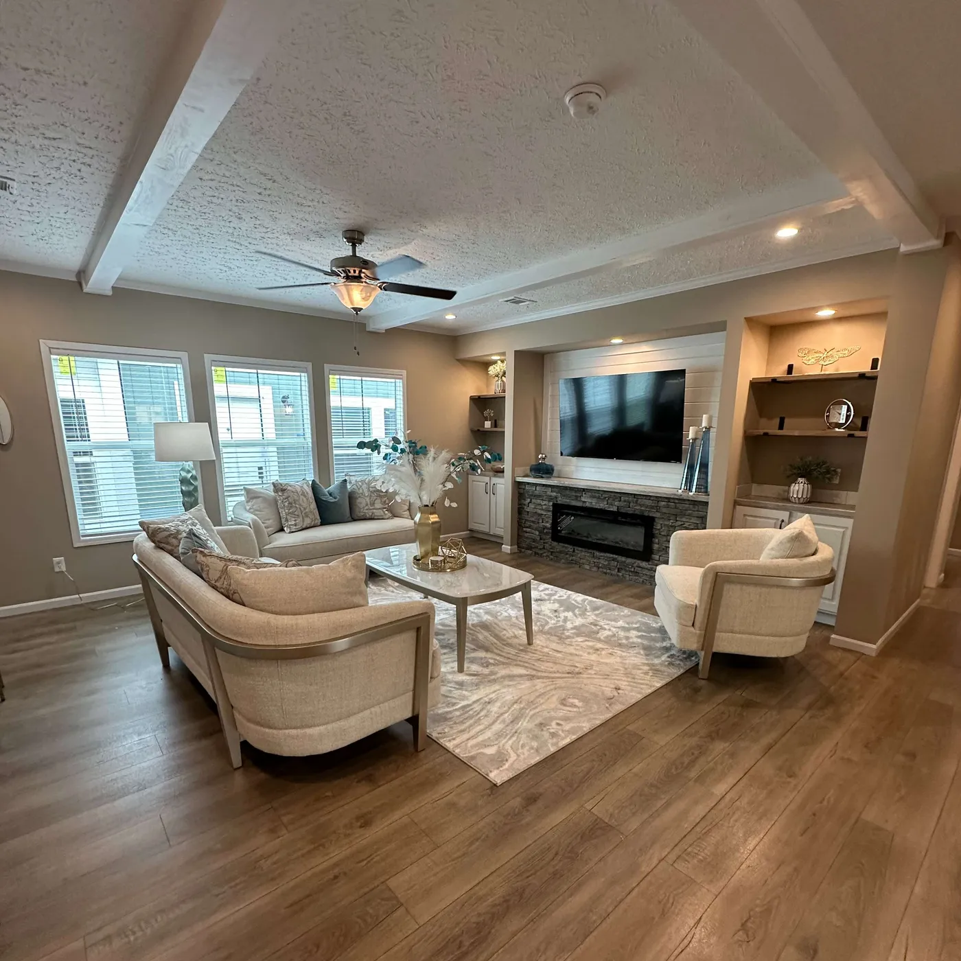 The THE HEXAGON Living Room. This Manufactured Mobile Home features 4 bedrooms and 3 baths.