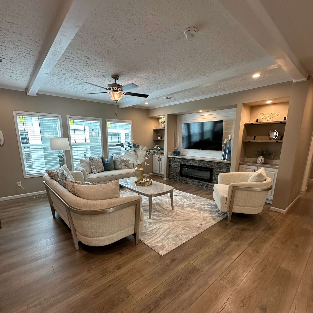 The THE HEXAGON Living Room. This Manufactured Mobile Home features 4 bedrooms and 3 baths.