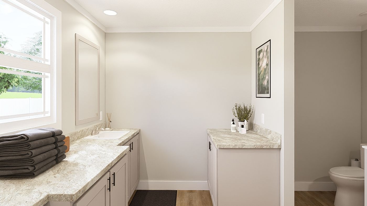 The THE BREEZE 64 Primary Bathroom. This Manufactured Mobile Home features 4 bedrooms and 2 baths.