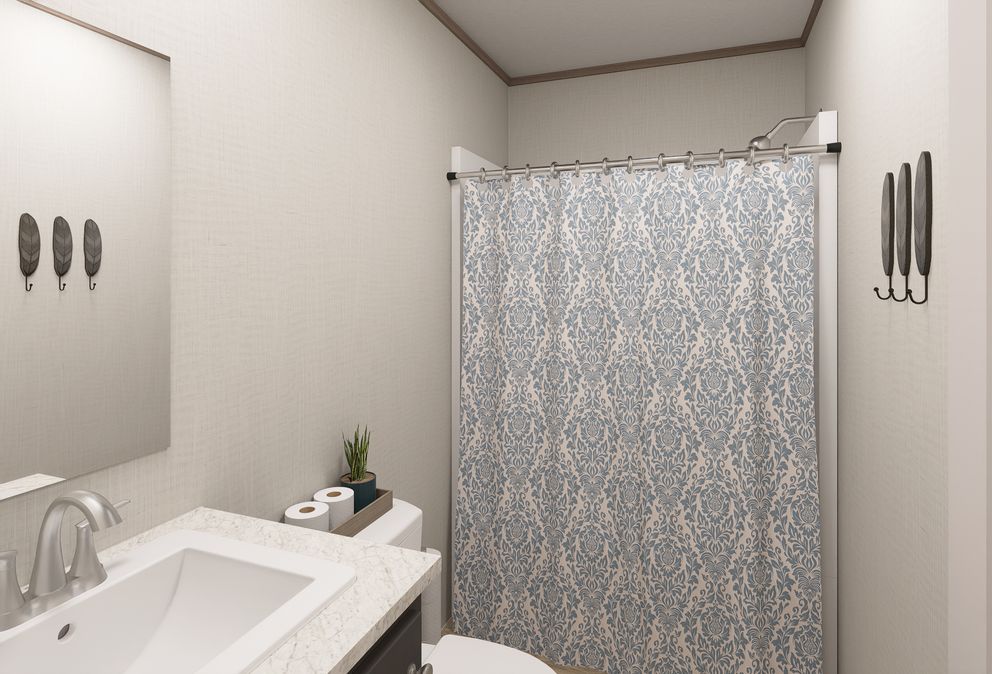 The ULTRA FLEX ANNIVERSARY PLUS Guest Bathroom. This Manufactured Mobile Home features 3 bedrooms and 2 baths.