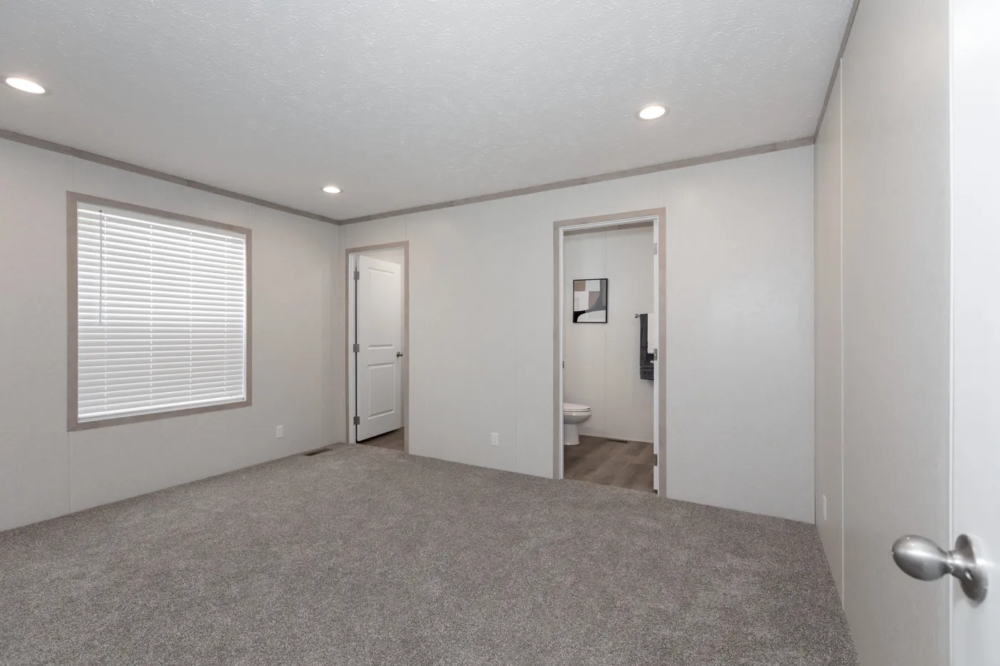 The 7616-4200 ADRENALINE Primary Bedroom. This Manufactured Mobile Home features 3 bedrooms and 2 baths.
