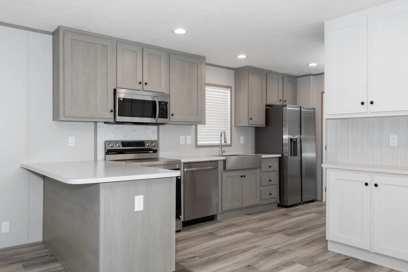 The THE ANNIVERSARY 76 Kitchen. This Manufactured Mobile Home features 3 bedrooms and 2 baths.