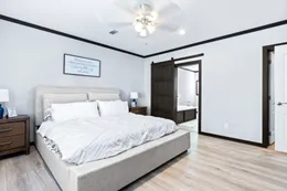The THE LOUIS Primary Bedroom. This Manufactured Mobile Home features 4 bedrooms and 3 baths.