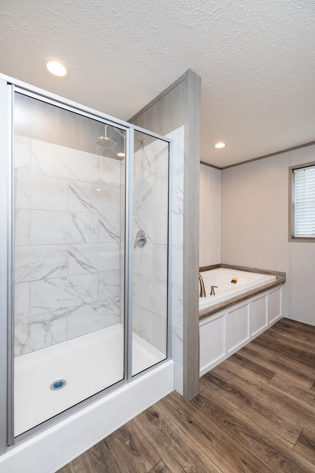 The FARM HOUSE 72 Primary Bathroom. This Manufactured Mobile Home features 4 bedrooms and 2 baths.