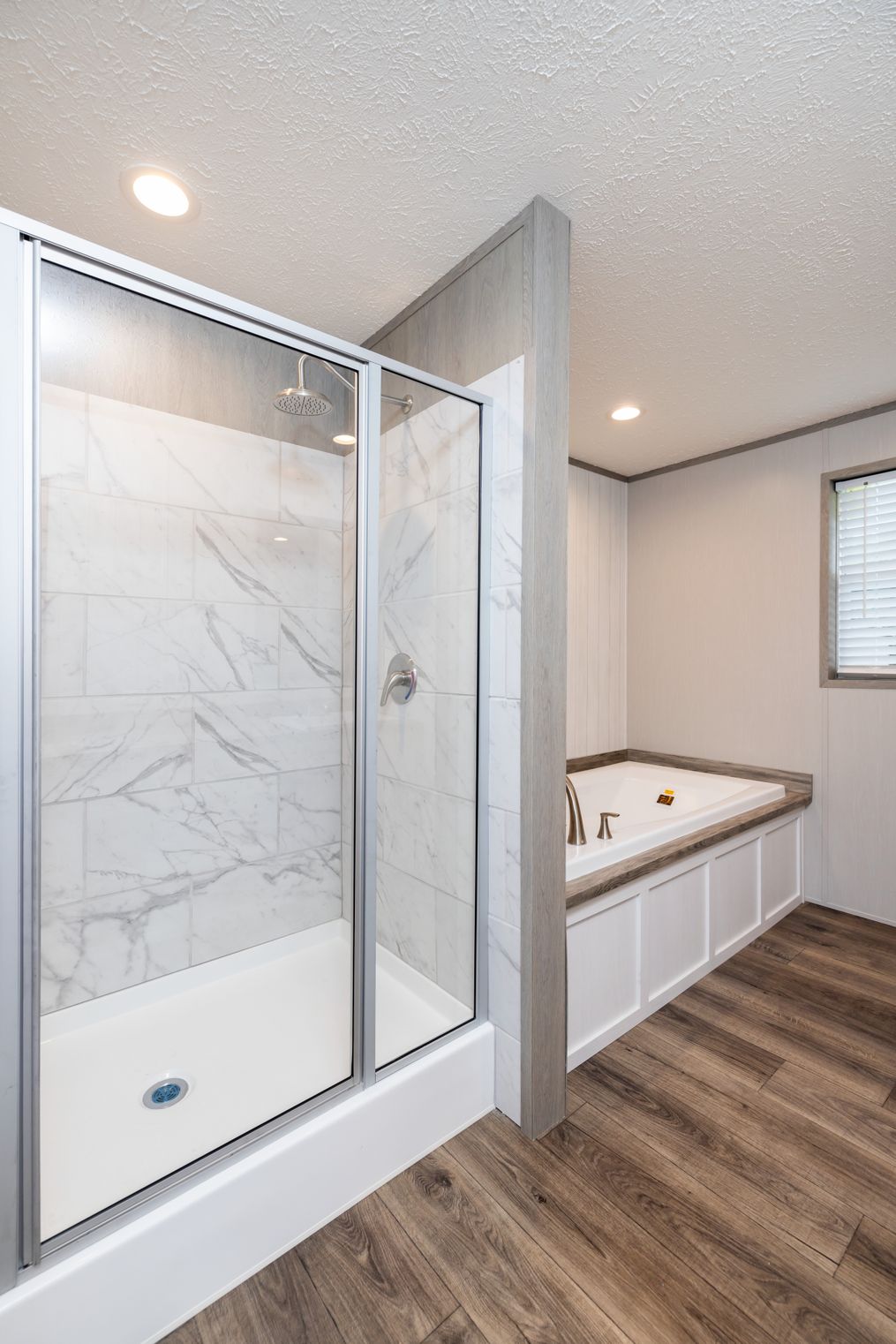 The FARM HOUSE 72 Primary Bathroom. This Manufactured Mobile Home features 4 bedrooms and 2 baths.