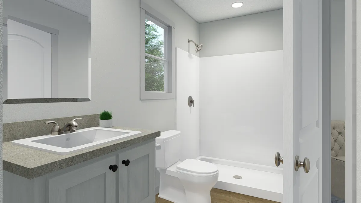 The BORN TO RUN Primary Bathroom. This Manufactured Mobile Home features 2 bedrooms and 2 baths.