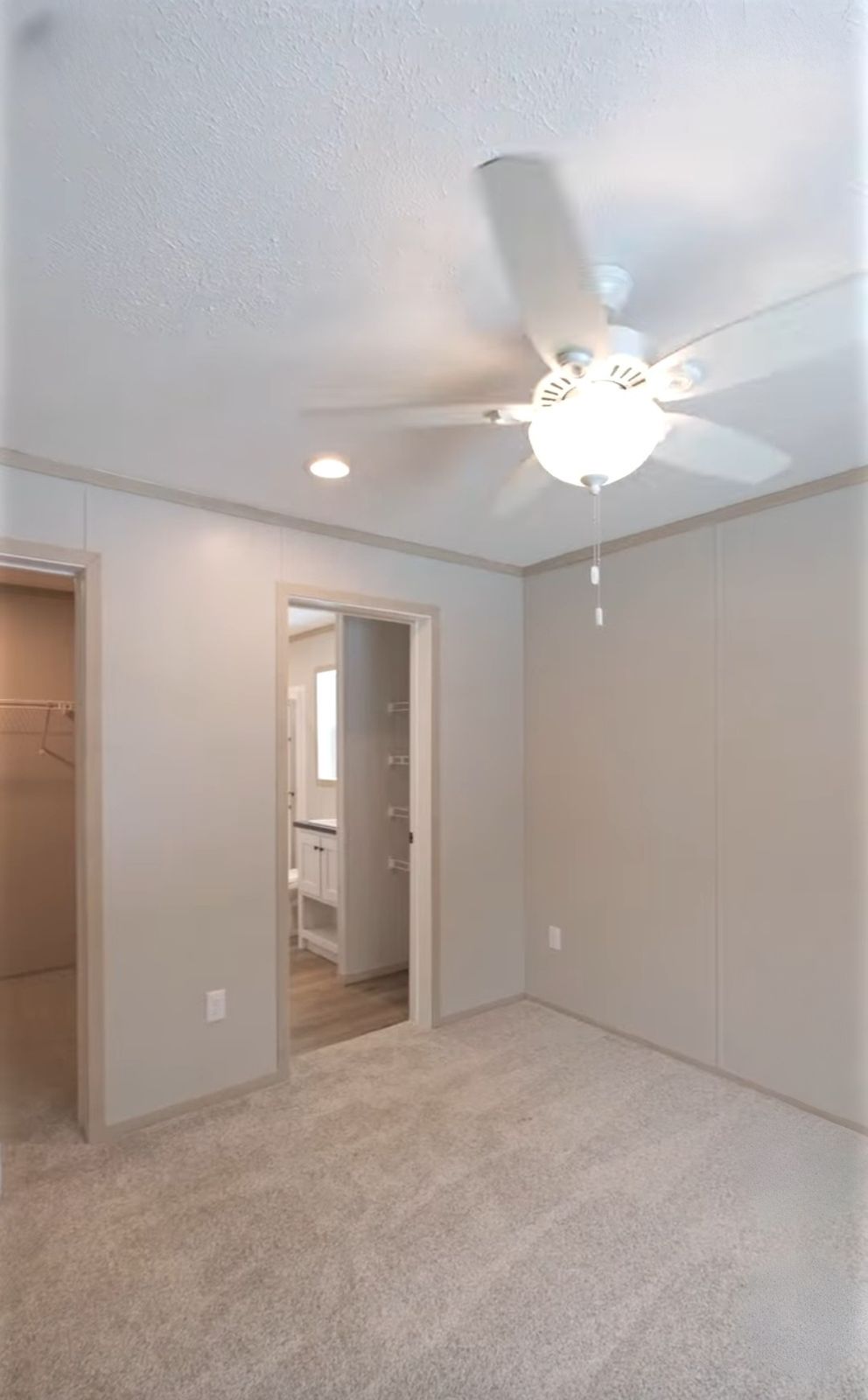 The TURQUOISE Primary Bedroom. This Manufactured Mobile Home features 2 bedrooms and 2 baths.