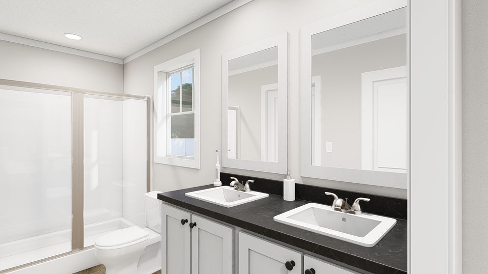 The HERE COMES THE SUN Primary Bathroom. This Manufactured Mobile Home features 3 bedrooms and 2 baths.