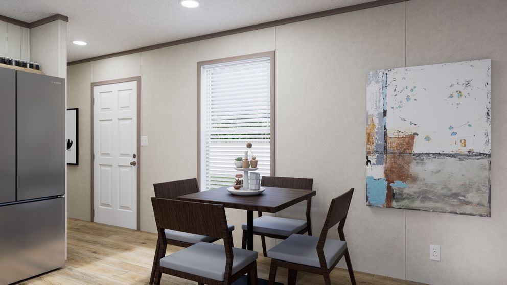 The 5216-CC05 OASIS 52 Dining Area. This Manufactured Mobile Home features 2 bedrooms and 1 bath.