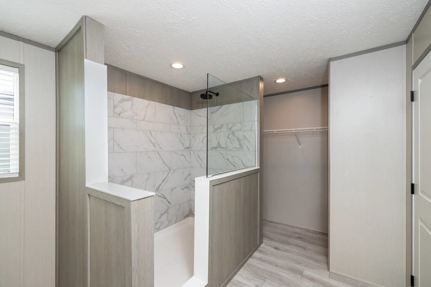 The SHOWER HOUSE Primary Bathroom. This Manufactured Mobile Home features 3 bedrooms and 2 baths.