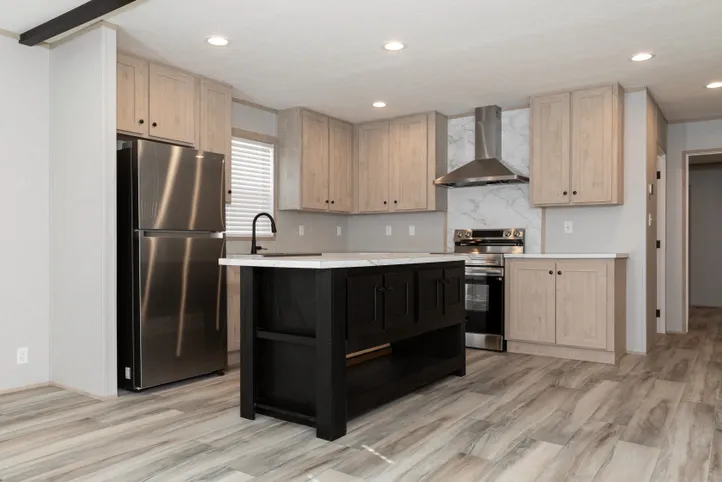The THE ANNIVERSARY ISLANDER Kitchen. This Manufactured Mobile Home features 3 bedrooms and 2 baths.
