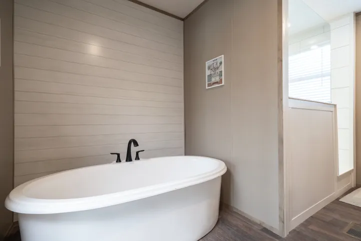 The FARMHOUSE BREEZE 72 Primary Bathroom. This Manufactured Mobile Home features 4 bedrooms and 2 baths.
