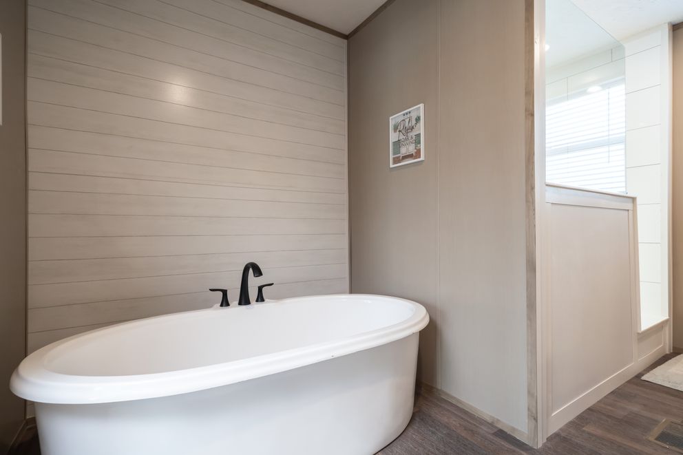 The FARMHOUSE BREEZE 72 Primary Bathroom. This Manufactured Mobile Home features 4 bedrooms and 2 baths.
