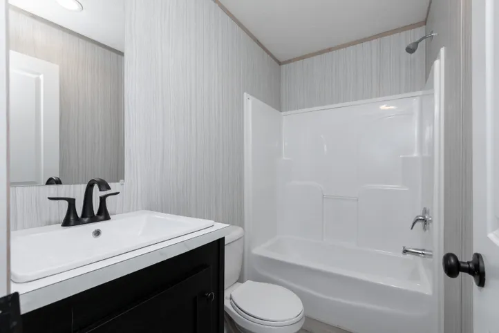 The THE ANNIVERSARY ISLANDER Guest Bathroom. This Manufactured Mobile Home features 3 bedrooms and 2 baths.