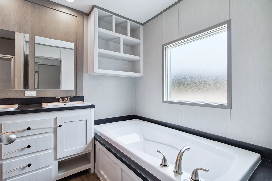 The ANNIVERSARY 16682F Primary Bathroom. This Manufactured Mobile Home features 2 bedrooms and 2 baths.