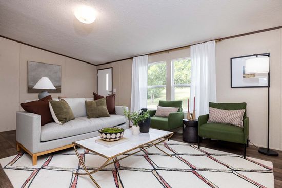 The PRIDE Living Room. This Manufactured Mobile Home features 4 bedrooms and 2 baths.