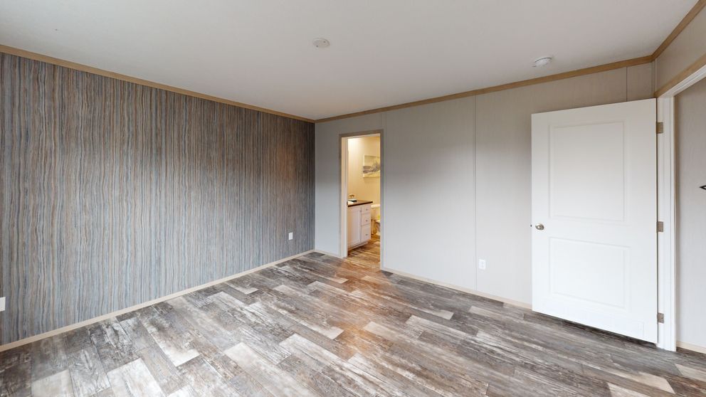 The HANCOCK Primary Bedroom. This Manufactured Mobile Home features 4 bedrooms and 2 baths.