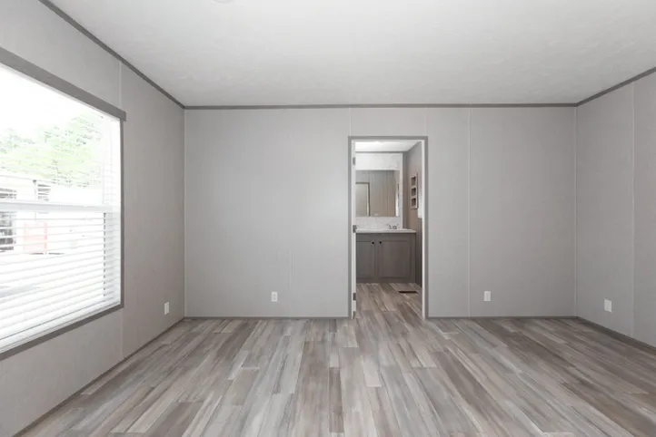 The BLAZER 66 F Primary Bedroom. This Manufactured Mobile Home features 3 bedrooms and 2 baths.