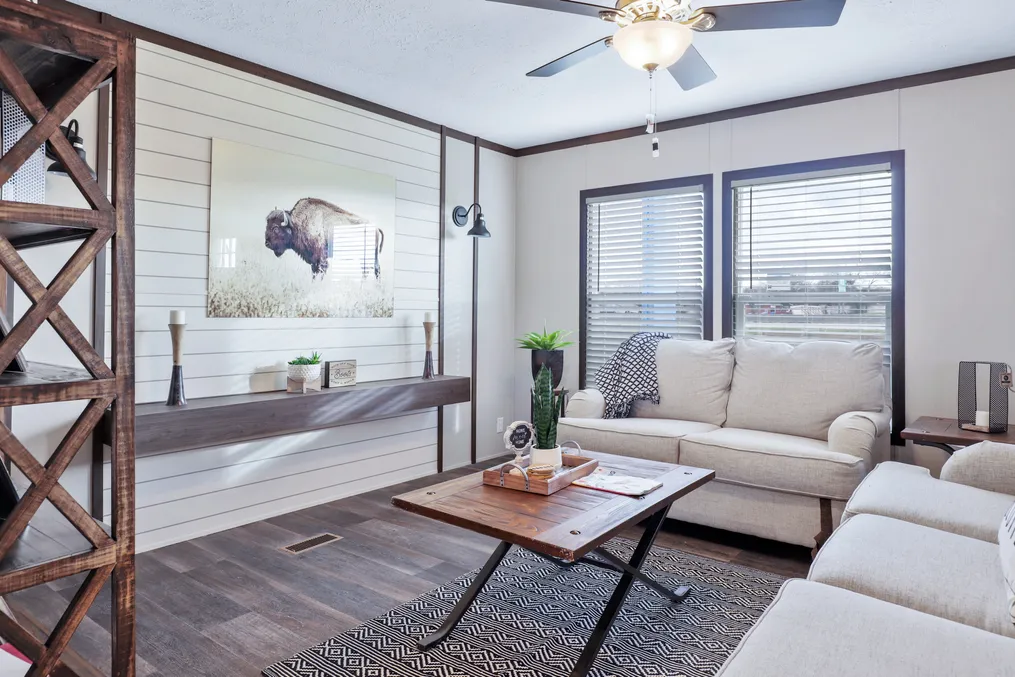 The BREEZE FARMHOUSE Living Room. This Manufactured Mobile Home features 3 bedrooms and 2 baths.