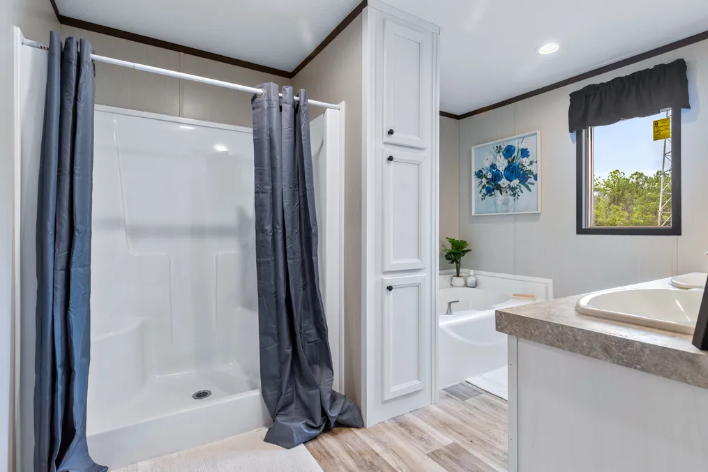 The COLOSSAL Primary Bathroom. This Manufactured Mobile Home features 3 bedrooms and 2 baths.