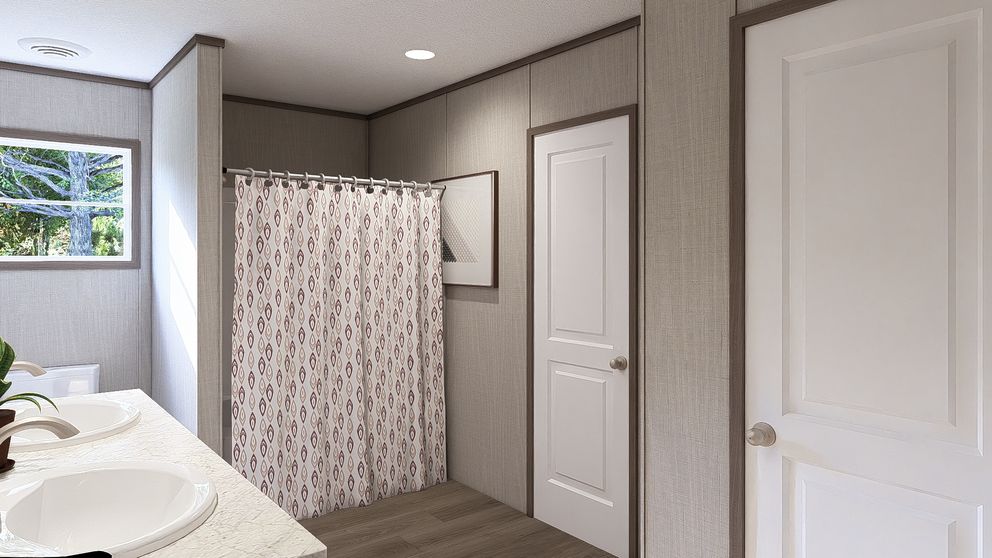 The LEGEND BIG BOY Primary Bathroom. This Manufactured Mobile Home features 4 bedrooms and 2 baths.