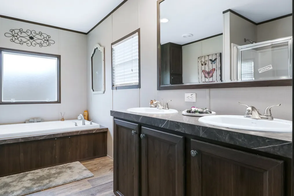 The THE REAL DEAL Primary Bathroom. This Manufactured Mobile Home features 3 bedrooms and 2 baths.