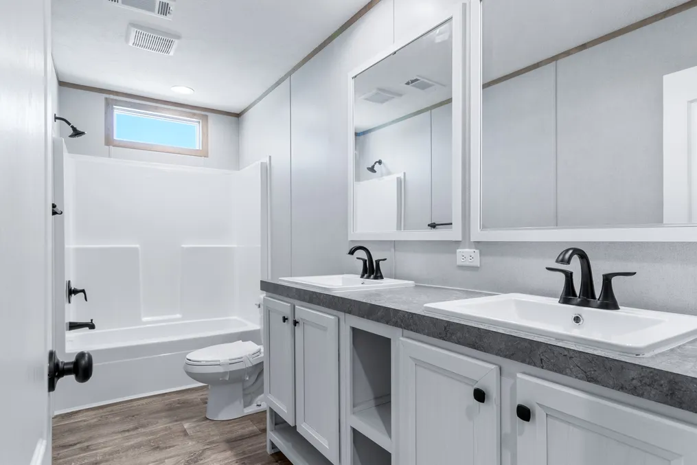 The THE RENEGADE Guest Bathroom. This Manufactured Mobile Home features 3 bedrooms and 2 baths.