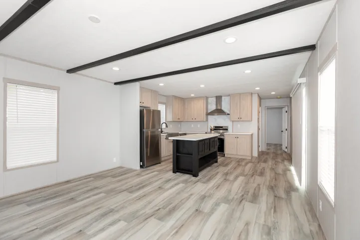 The THE ANNIVERSARY ISLANDER Living Room. This Manufactured Mobile Home features 3 bedrooms and 2 baths.