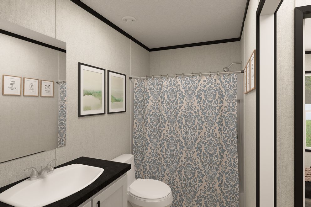 The THE MOUNTAINEER 48 Guest Bathroom. This Manufactured Mobile Home features 3 bedrooms and 2 baths.