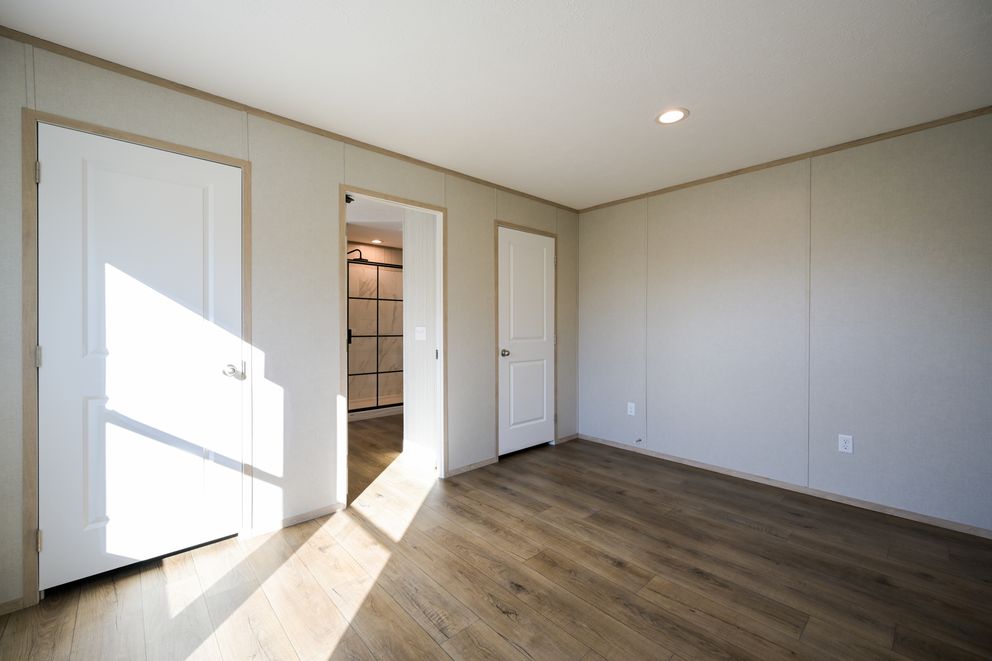 The TIGER'S EYE 7416-456 Primary Bedroom. This Manufactured Mobile Home features 3 bedrooms and 2 baths.