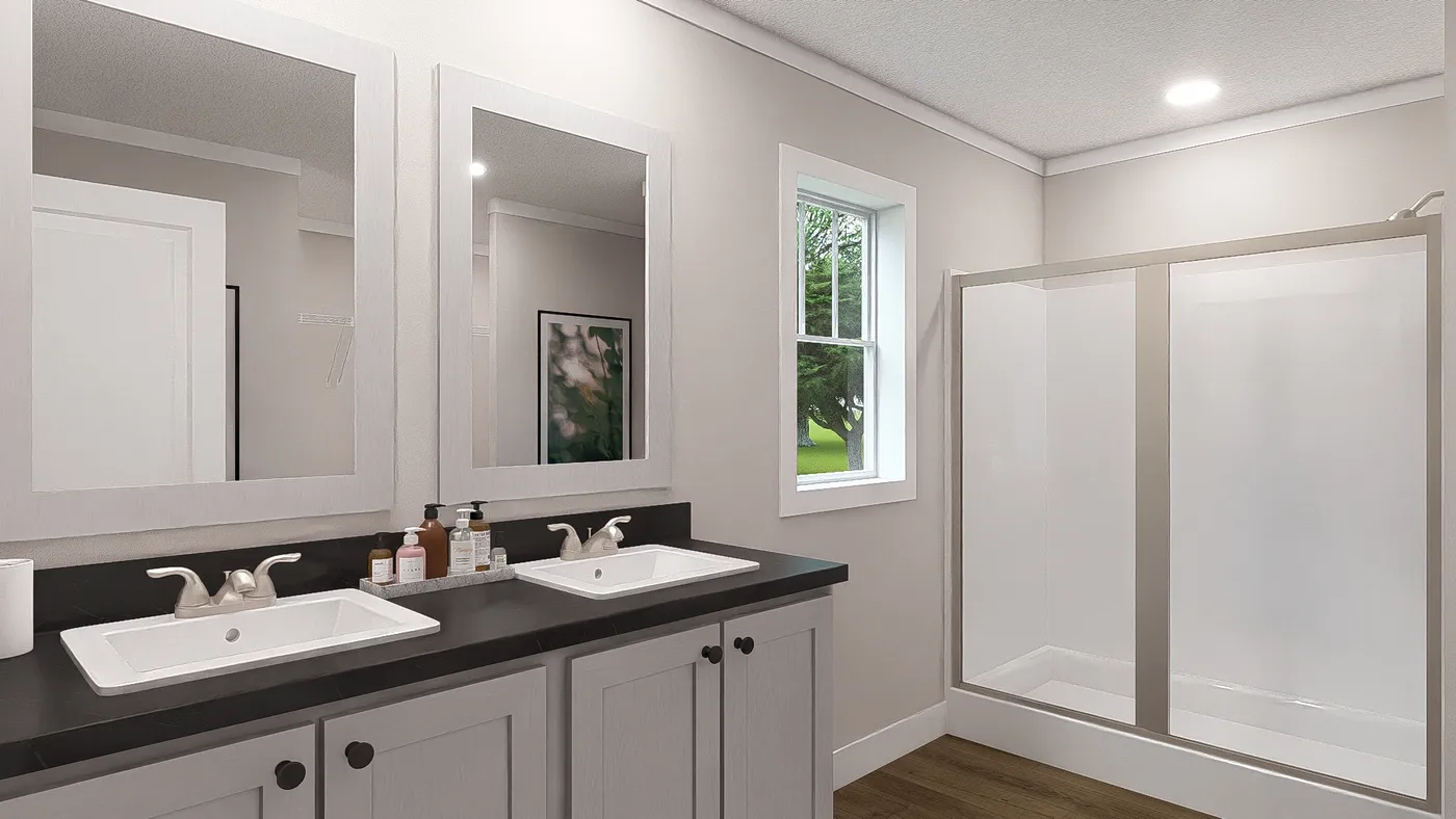 The LET IT BE Primary Bathroom. This Manufactured Mobile Home features 3 bedrooms and 2 baths.