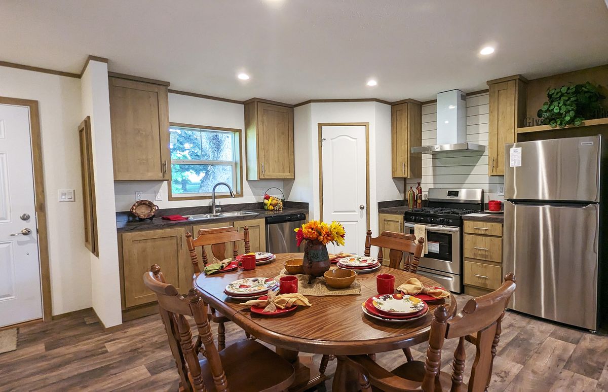 The LIFESTYLE 65-2 Dining Area. This Manufactured Mobile Home features 3 bedrooms and 2 baths.
