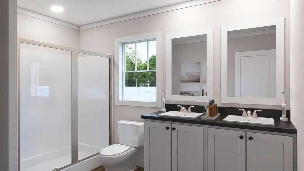 The WHOLE LOTTA LOVE Primary Bathroom. This Manufactured Mobile Home features 3 bedrooms and 2 baths.