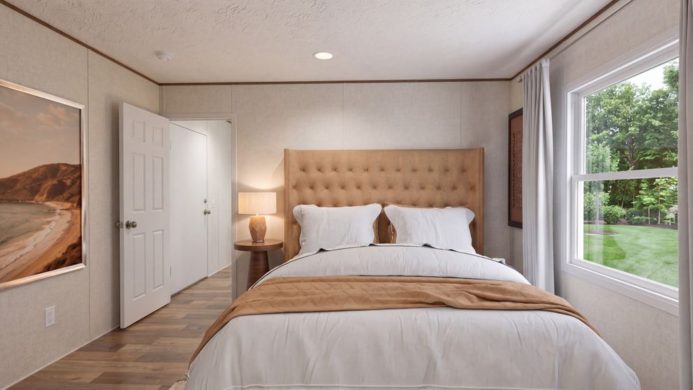 The HICKORY Primary Bedroom. This Manufactured Mobile Home features 3 bedrooms and 2 baths.