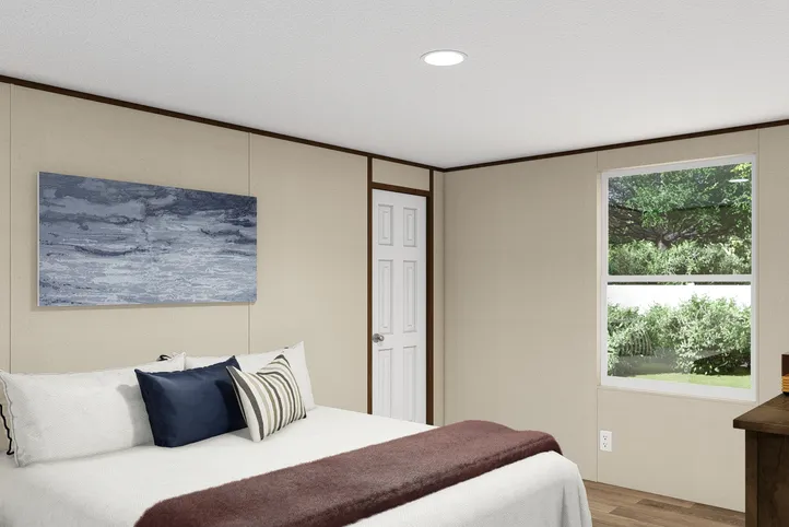 The THRILL Primary Bedroom. This Manufactured Mobile Home features 3 bedrooms and 2 baths.
