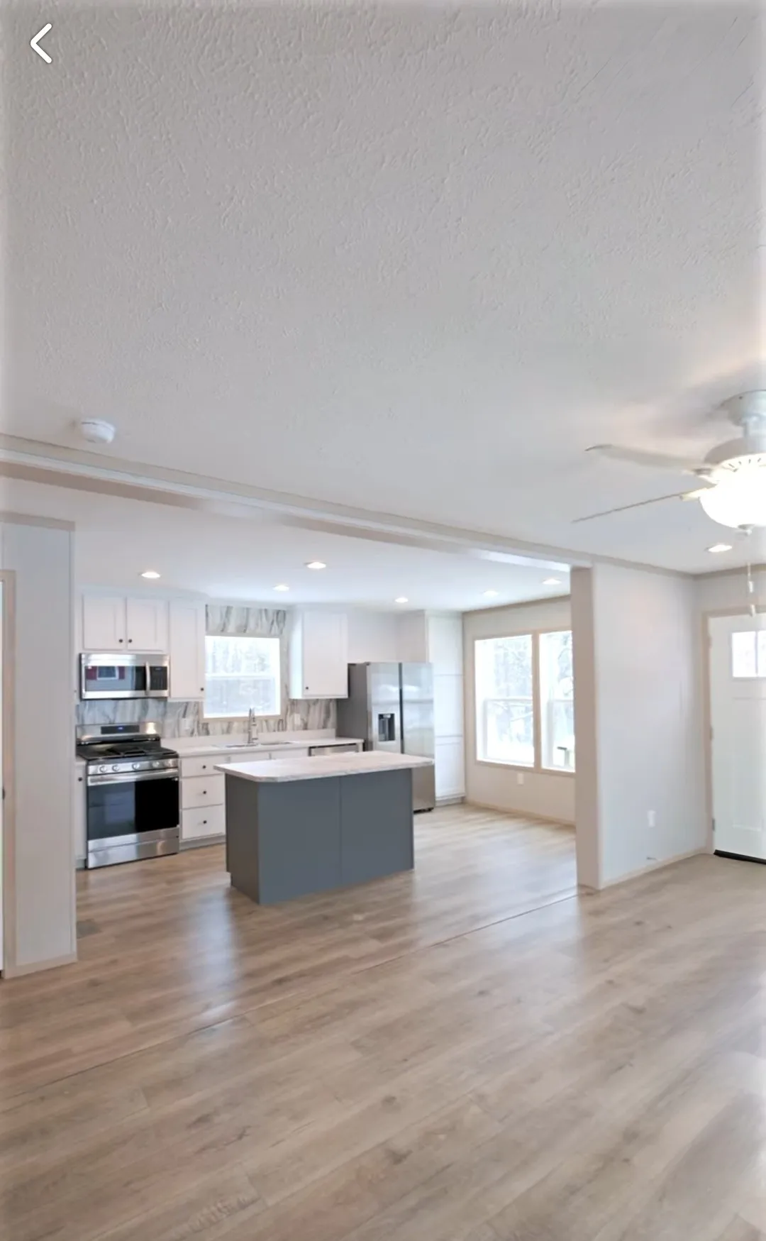The TURQUOISE Living Room. This Manufactured Mobile Home features 2 bedrooms and 2 baths.