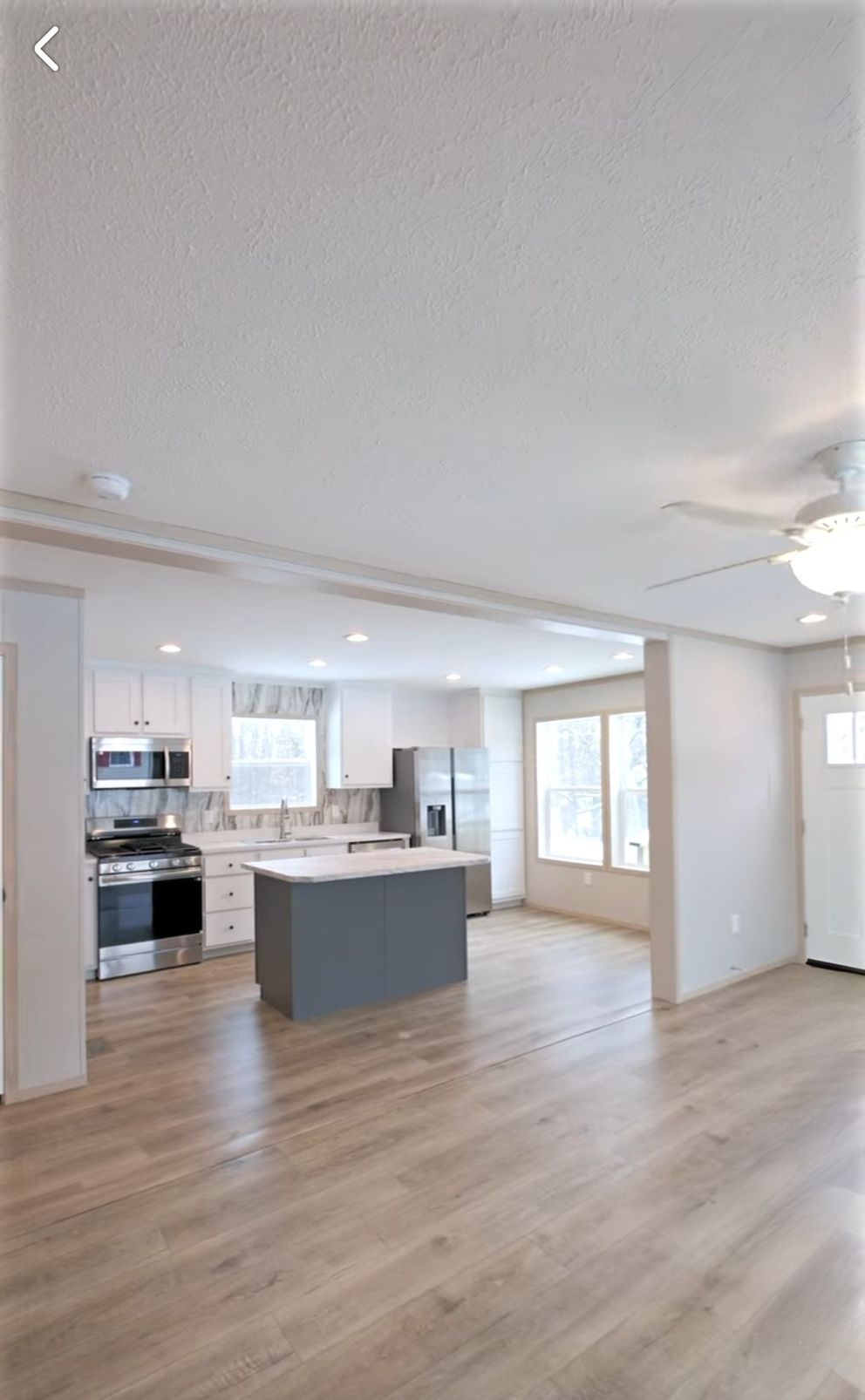The TURQUOISE Living Room. This Manufactured Mobile Home features 2 bedrooms and 2 baths.