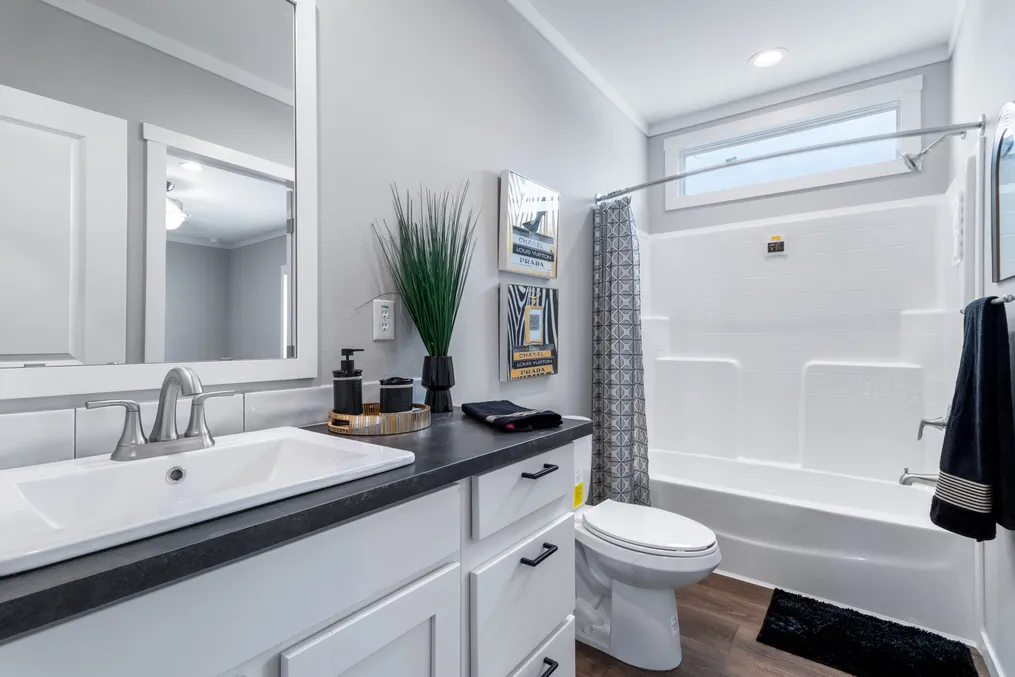 The THE CHANEL Guest Bathroom. This Manufactured Mobile Home features 4 bedrooms and 3 baths.