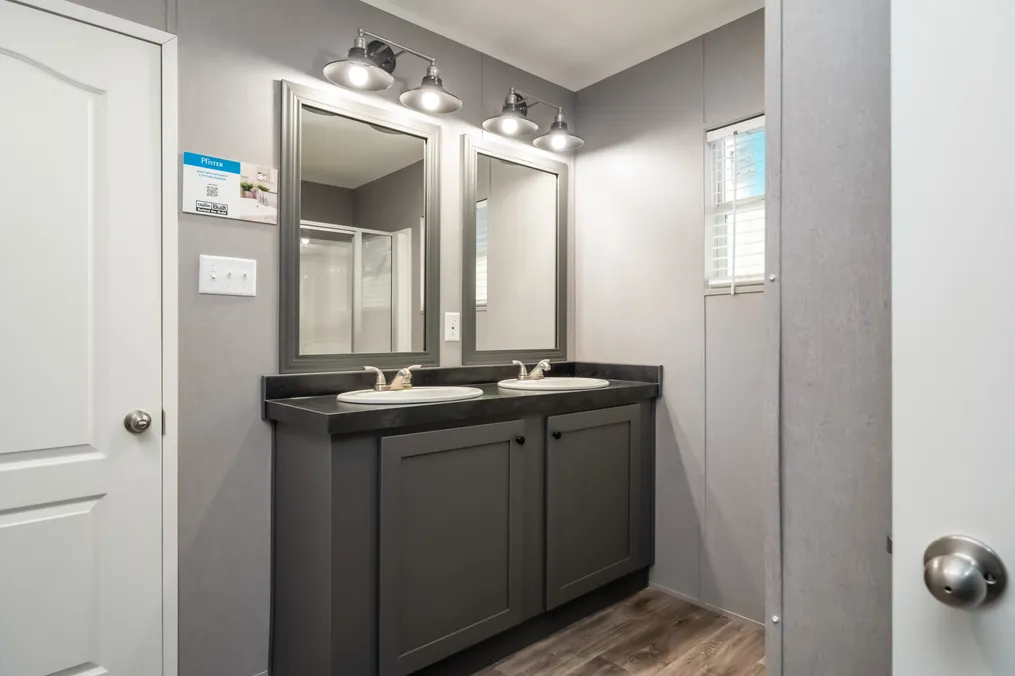 The TRADITION 3268B Primary Bathroom. This Manufactured Mobile Home features 5 bedrooms and 3 baths.