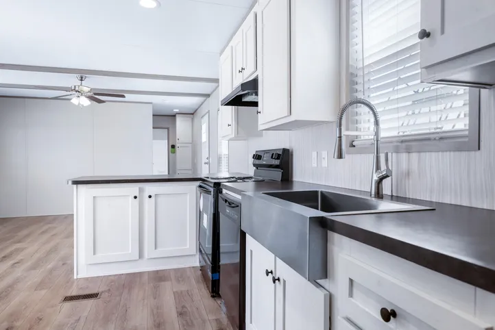 The ANNIVERSARY 16602A Kitchen. This Manufactured Mobile Home features 2 bedrooms and 2 baths.