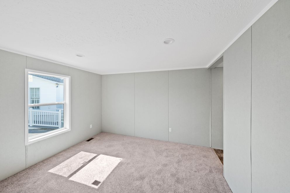 The ZIRCON Primary Bedroom. This Manufactured Mobile Home features 3 bedrooms and 2 baths.