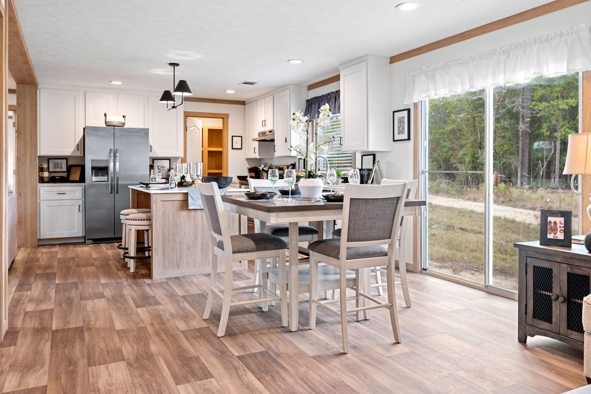 The THATCHER Dining Area. This Manufactured Mobile Home features 4 bedrooms and 2 baths.
