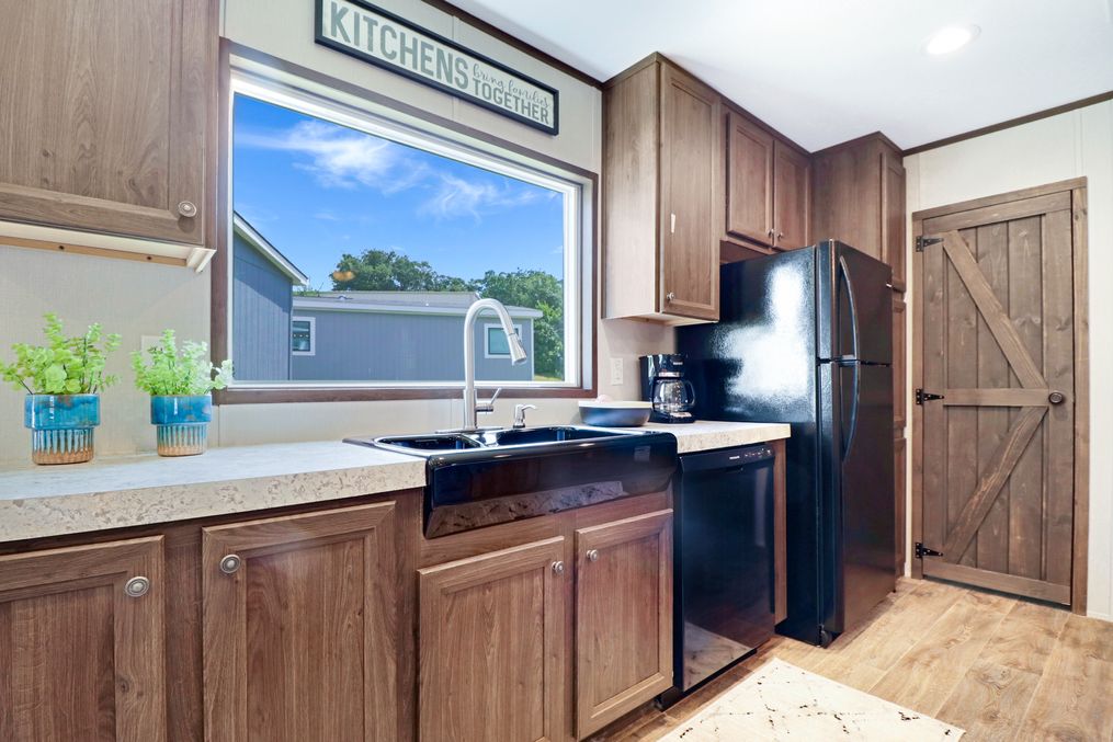 The THE ANNIVERSARY 2.1 Kitchen. This Manufactured Mobile Home features 3 bedrooms and 2 baths.