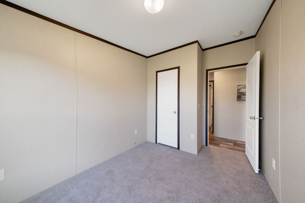 The GARNET Guest Bedroom. This Manufactured Mobile Home features 3 bedrooms and 2 baths.