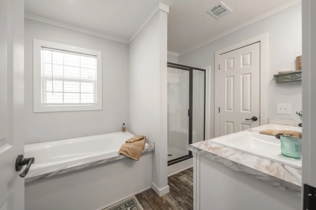 The THE DEWEY Primary Bathroom. This Manufactured Mobile Home features 3 bedrooms and 2 baths.